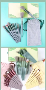 Detail view of 13-piece makeup brush sets with colorful handles and matching storage pouches