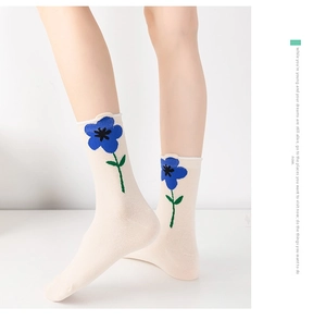 Detail of cream calf socks with blue floral prints and breathable cotton texture