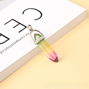 Macro shot of a hexagonal crystal pendant featuring a green to purple gradient color
