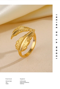 Detailed close-up of a gold feather ring showing intricate texture and polished finish