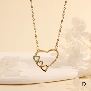 Close-up of heart necklace with sparkling crystals and colorful gems on a display tray