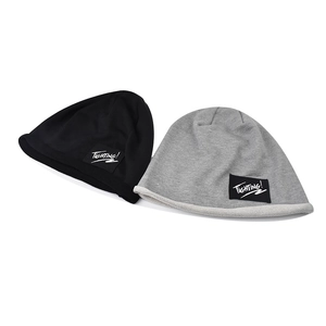 Close-up of black and grey knit beanies featuring white Fighting lettered patches