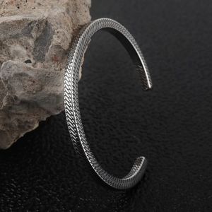 Minimalist silver titanium steel open bangle with diamond pattern on natural rock
