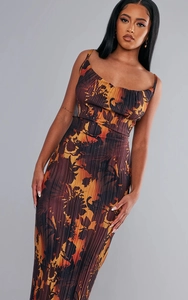 Detail of plissé fabric texture on slim fit cami dress with sunset floral print