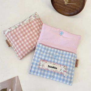 Quilted cotton sanitary pouch detail showing pink and blue grid patterns and button closure