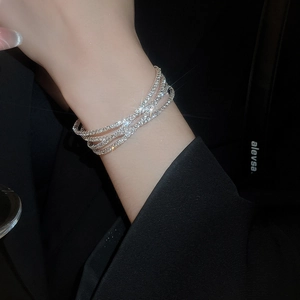 Close-up of a silver multi-layer wrap bracelet featuring brilliant pavé-set crystals