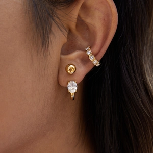 Detail of 18K gold plated ear cuff and earrings set featuring white zircon stones on model