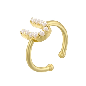 Detail of a gold open ring featuring elegant white pearls on a U-shaped setting