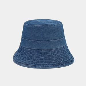 Detail view of deep blue denim bucket hat featuring white multi-row stitching on the brim