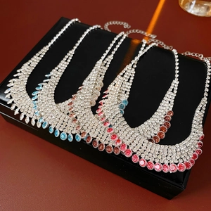 Detail of multi-row tassel necklaces with colorful rhinestones on black jewelry box