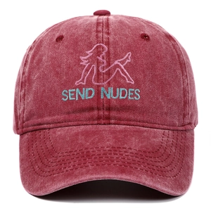 Close-up of pink silhouette embroidery and blue text on burgundy washed baseball cap
