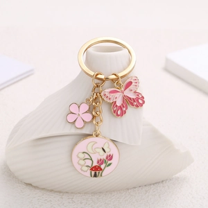 Pink floral butterfly pendant keychain with gold alloy rings and decorative charms for bags