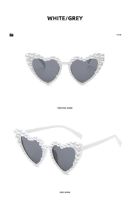 Front and side views of heart-shaped white sunglasses with elegant pearl embellishments
