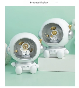 Macro detail showing astronaut miniatures and planets inside white resin ornaments
