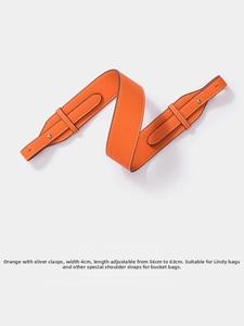 Close-up of orange litchi texture leather shoulder strap with silver metal buckle detail