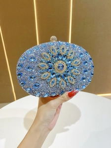 Detail of sunflower rhinestone evening clutch bag with blue crystals and silver metal base