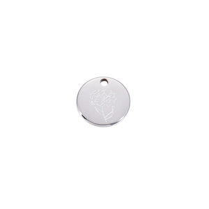 Detailed macro view of a silver stainless steel round pendant with floral etching