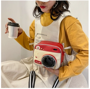 Retro camera-shaped crossbody bag with red and cream leather details and dual straps