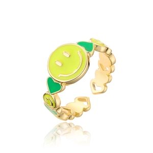 Close-up of gold-plated ring with yellow smiley face and green enamel heart detail