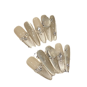 Sparkling champagne cat eye press-on nails with luxury rhinestones and star charms