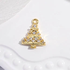Detailed close-up of a golden Christmas tree pendant with sparkling rhinestone inlay