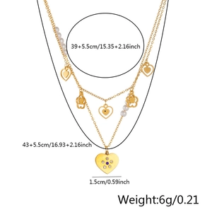 Detail showing gold layered necklace with pearl, heart and flower pendants and size measurements