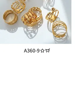 Close-up of gold-plated rings set featuring intertwined geometric and twist patterns