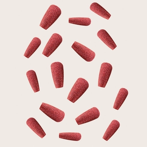 Flat lay of 14 pieces of red matte glitter press-on nails in a long coffin shape