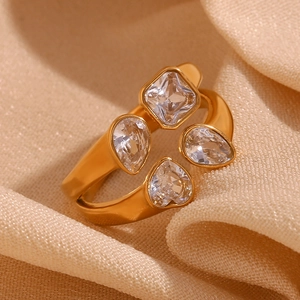 Macro detail of 18K gold plated ring with square, teardrop and heart cubic zirconia gems