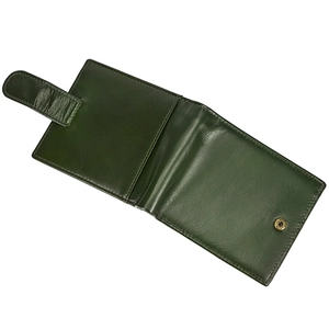 Detail of dark green genuine leather tri-fold wallet with snap closure and strap
