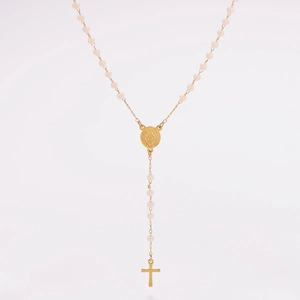Detail of beaded rosary necklace with gold-plated religious medal and cross pendant