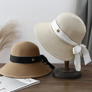 French straw sun hats with elegant bows and gold rose buckles in cream and tan colors
