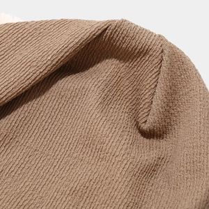 Macro shot of brown ribbed knit fabric showing detailed texture and stitching quality