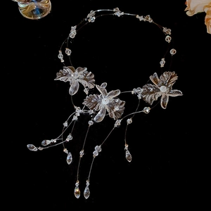 Detail of transparent crystal flower necklace with elegant drop tassels and beads