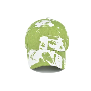 Detailed view of the green and white tie-dye cotton twill fabric of the baseball cap