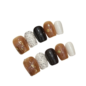 Amber marble moon press-on nails set with gold foil and minimalist chic patterns
