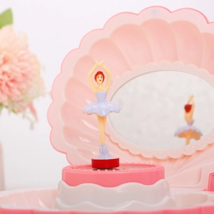 Close-up of shell music box featuring rotating ballerina dancer and interior mirror