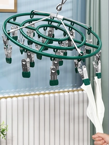 Close-up of windproof drying rack with non-slip soft rubber clips holding white socks