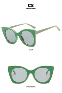 Detail view of cat eye glasses frames in dual-tone green with stylish gray tinted lenses