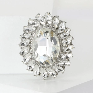 Macro detail of luxury oval crystal sunflower brooch with silver setting and rhinestones