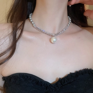 Detail of grey beaded necklace with crystal spacers and a large white pearl pendant