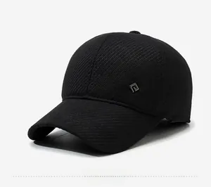 Detail view of black textured baseball cap showing the side logo and striped fabric texture