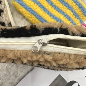 Close-up of the metal zipper closure on the brown leopard print teddy plush cosmetic bag