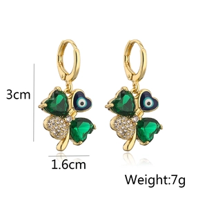 Detailed view of gold-plated clover earrings with evil eye and green heart zircon