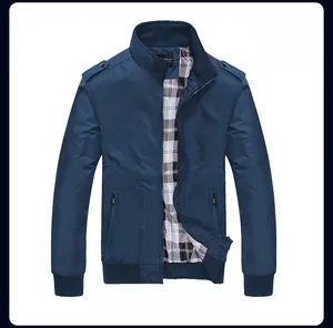 Close-up of navy blue Harrington jacket with classic plaid lining and ribbed cuffs