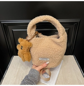 Détail du sac seau beige en laine d'agneau avec breloque ours et bandoulière