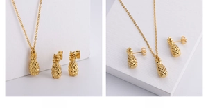 Detailed view of a gold pineapple jewelry set with necklace and stud earrings