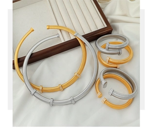 Detail of elegant gold and silver spiral bracelets with sparkling rhinestones decoration