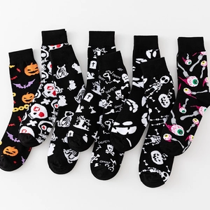 Halloween crew socks featuring pumpkins, ghosts and skulls in a flat-lay arrangement