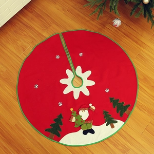 Detailed view of red Christmas tree skirt with Santa Claus embroidery on wooden floor